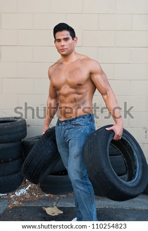 Athletic young man with auto tires
