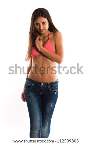 Beautiful slender Romanian brunette in a bikini top and jeans