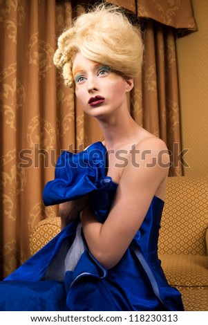 Slender pale blonde in a blue gown