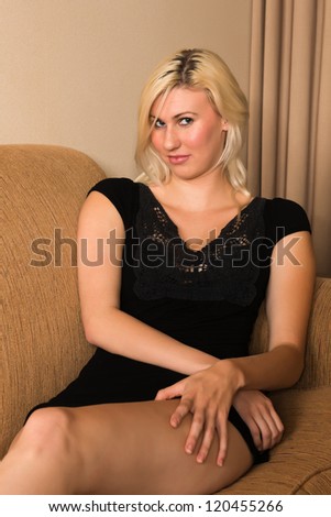Tall young blonde in a short black dress