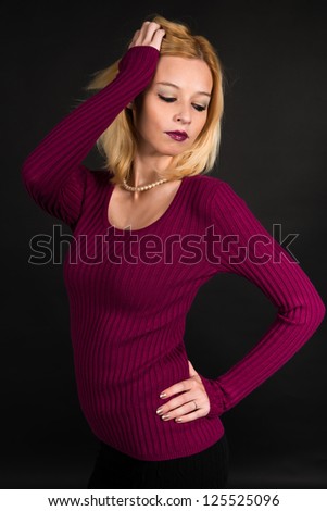 Pretty blonde woman in a purple sweater