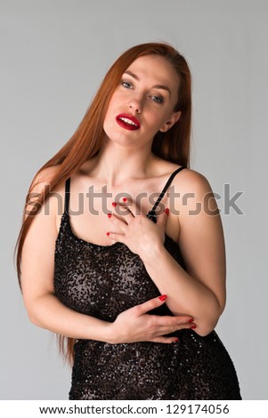 Pretty young redhead in a sheer black dress