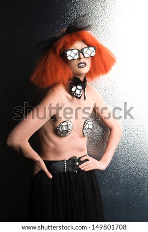 Slender woman with red wig and mirrored glasses