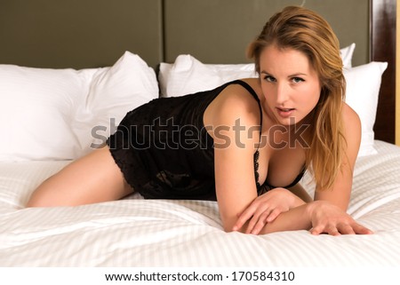 Pretty young blonde woman in a black chemise