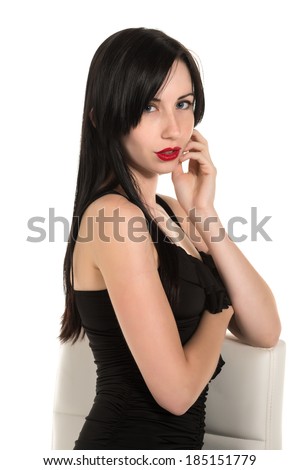 Pretty black haired woman in a black party dress