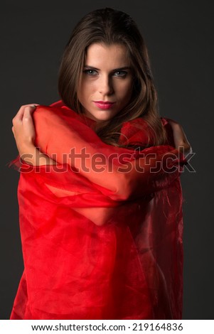 Beautiful slender Ukrainian woman wrapped in red tulle