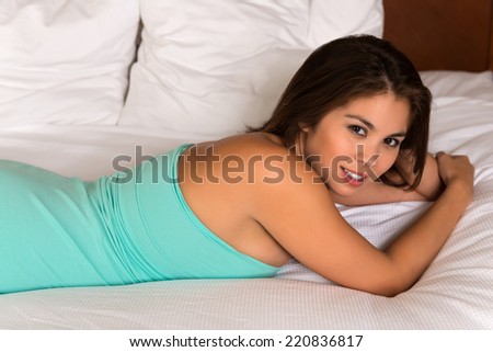 Beautiful young Eurasian woman in a teal tube dress
