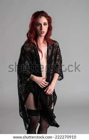 Slender young redhead covered with black lace