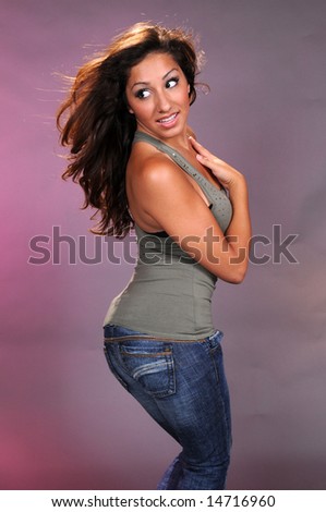 Brown haired beauty in a green top and blue jeans