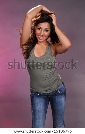 Brown haired beauty in a green top and blue jeans