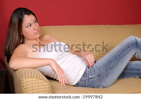 Pretty teen sacked out on a couch