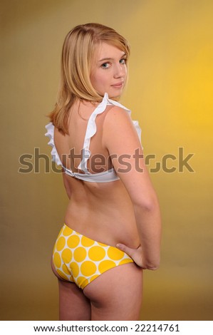 Pretty blonde teenager in a modest bikini