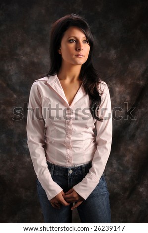 Pretty young brunette in a pink shirt and blue jeans