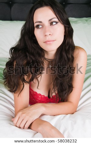 Pretty young Latina lying on a bed