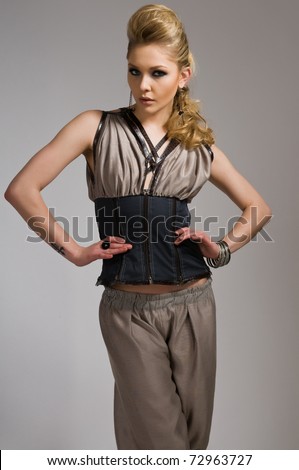 Beautiful tall blonde in a vest and loose pants