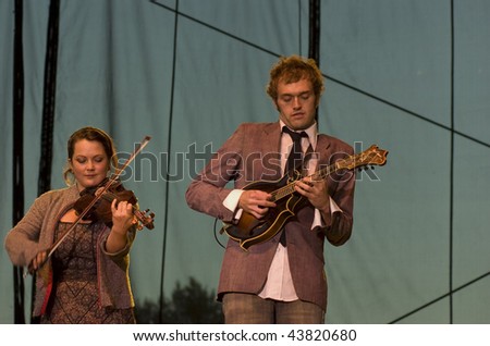 REDMOND, WA - AUG 11: Singer and violin player Sara Watkins with singer and mandolin player Chris Thile  of Nickel Creek performs on stage at Marymoor Amphitheater August 11, 2006 in Redmond, Wa.