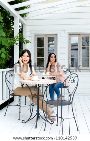 Beautiful young business woman drinking tea. Portrait of asian.