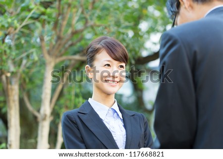 Young asian smiling businesswoman and businessman