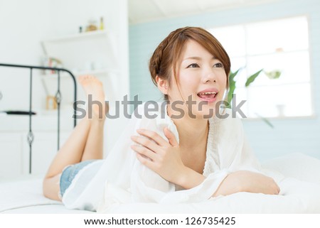 Beauty asian woman relaxing in the bed room