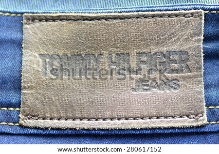 CIRCA JUNE 2014   KWIDZYN: Closeup of Tommy Hilfiger label on blue jeans. Tommy Hilfiger is lifestyle brand founded by American fashion designer Thomas Jacob Hilfiger (born in 1951).