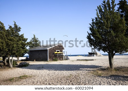 The beach hut at Orient beach state park. Several rare red cedar trees are pictured . Orient Point, Long Island, New York.