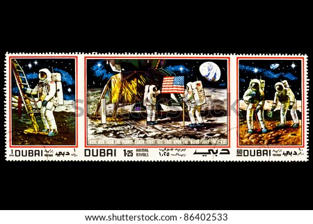 DUBAI - CIRCA 1970\'s : A stamp printed in DUBAI shows the First men landing on the moon, circa 1970\'s
