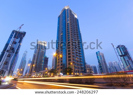 DUBAI, UAE - MARCH 30: Traffic on the streets of Dubai Marina on March 30, 2014, UAE. Dubai Marina is a district in Dubai with artificial canal skyscrapers who accommodates more than 120,000 people.