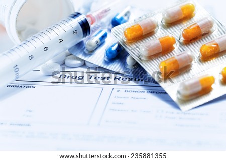 Syringe with glass vials and medications pills drug on white