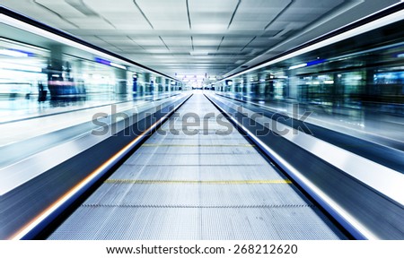 symmetric moving blue escalator inside contemporary airport, hong kong