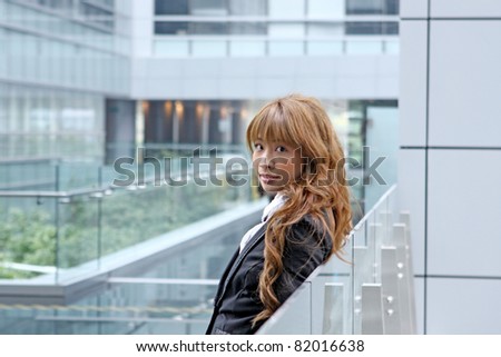 Happy business woman in office with smiling expression.