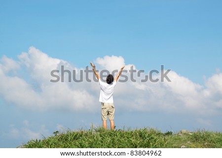 Meeting of the sky. The man on high mountain with the hands lifted above, on a background of blue sky