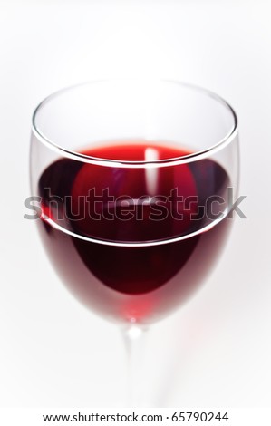 Red wine in glass closeup isolated on white background