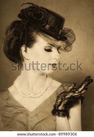 vintage styled portrait of a beautiful lady in hat with beads and lace gloves.