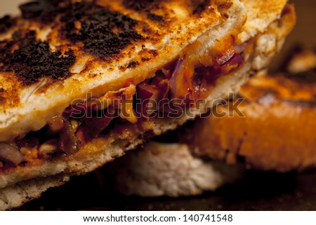 Toasted cheese, tomato and onion sandwich done on the BBQ.  Toasted  sandwich.