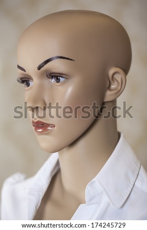 Head of a female mannequin in profile wearing a white shirt. Mannequin.