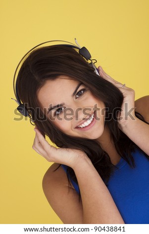 Young woman listing to music on a set of headphones.Enjoying music.
