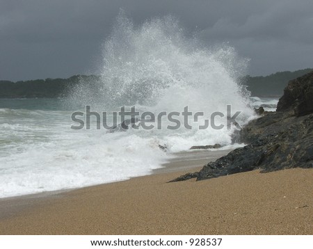 huge wave breaking on the rocks