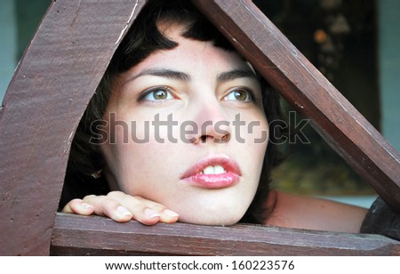 Young woman looking into the distance through the wheel