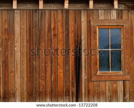 Side of a wooden barn with planks and window