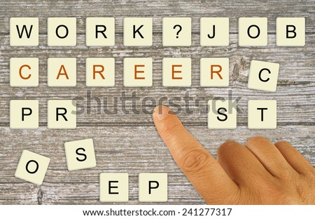 Career planning, recruitment etc. Finger pointing making choice with letter tiles.