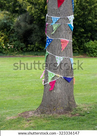 Festive tree with bunting around. Variation on the theme of yarn bombing