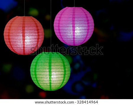 Chinese paper lanterns, lit, dark defocussed background. Christmas, new year, general celebrations.