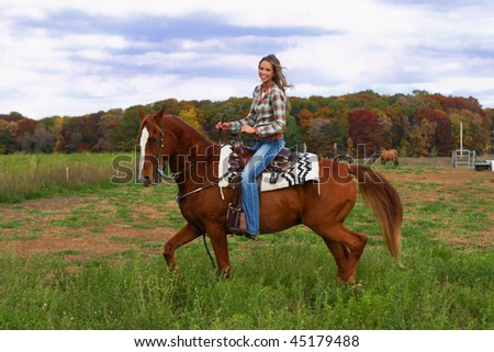 Beautiful young woman riding a handsome horse.