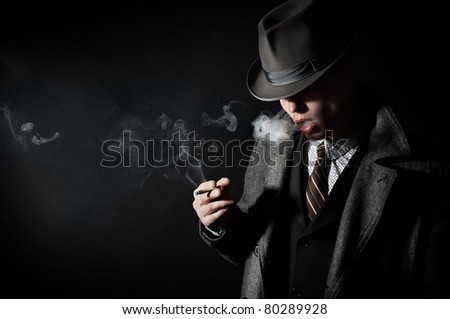 Contrast tinted in the old-style portrait of a man in a stylish elegant business suits, smoking cigarettes