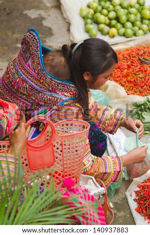 BAC HA, VIETNAM - SEPTEMBER 29: Unidentified women of the Flower H\'mong ethnic minority People at market on September 29 2012 at Bac Ha, Vietnam. There are about 800,000 thousand H\'mongs in Vietnam.