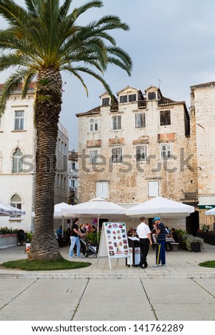 TROGIR, CROATIA - MAY 10: Tourists visit Old Town on May 10, 2013 in Trogir, Croatia. Trogir, as a UNESCO World Heritage Site, is one of most visited places in Croatia.