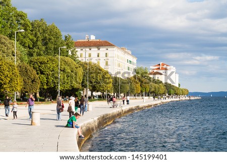 ZADAR, CROATIA - MAY 13: Tourists enjoy Mediterranean Sea on May 13, 2013 in Zadar, Croatia. 10 million tourists visit Croatia every year, 8.5 of them foreign visitors (National Stats Bureau)