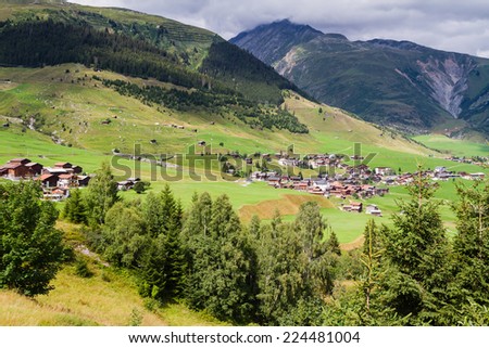 View of a typical Swiss village in a valley. Swiss Alps