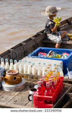 CAN THO, VIETNAM - SEP 14, 2011: Boy on floating market in Mekong river delta. Cai Rang and Cai Be markets are very popular among the local citizens and tourists.