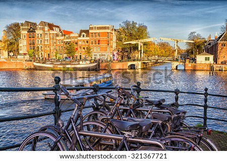 AMSTERDAM, THE NETHERLANDS - NOVEMBER 10: Bicycles lining a bridge over the canals in Amsterdam, The Netherlands on November 10, 2014.